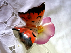 A butterfly resting on a vintage stone quarry flower