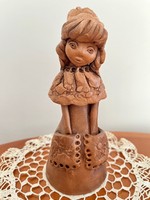 Ceramic figurine of a girl in a dress with pockets