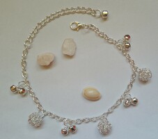 Silver colored anklet with small bells