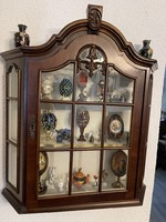 Beautiful curved carved wooden wall display case with white interior.
