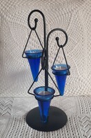 Blue glass candle holder on a black metal stand number 3