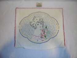 Old, hand-embroidered decorative pillow with a little girl's head