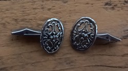 Pair of silver colored cufflinks
