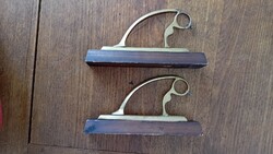 A pair of copper cornice rod holders