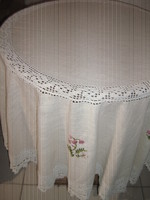 Beautiful round hand-crocheted tablecloth with a lace edge and inset floral embroidery