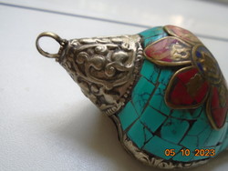 Tibetan talisman with silver and turquoise covering, applied bronze Buddhist symbols with coral and lapis stones