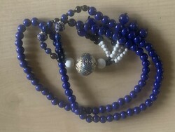 A string of beads made of painted glass beads with a lapis lazuli effect