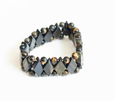 Bracelet made of polished faceted flat rhombus and spherical tiger eye pearls
