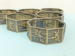 Industrial bronze napkin ring set decorated with sports symbols
