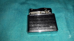 Old unmarked elegant steel lighter with metal casing as shown in the pictures