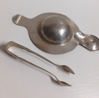 An alpaca tea strainer with a handle that can be placed on the top and rim of an old tea mug with sugar tweezers