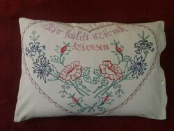 Old decorative cushion cover with text embroidered on both sides