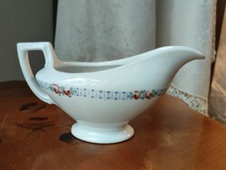 A beautiful antique porcelain sauce pourer with a beautiful geometric border and studded with small flowers