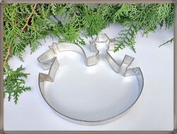 A giant metal cookie cutter with a rocking cowboy.