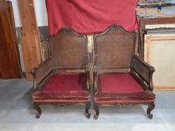 A wicker neobaroque armchair with a pair of burgundy upholstery