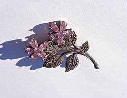 Silver brooch with many stones