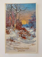 Old Christmas postcard with golden sun in snowy forest