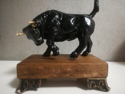Enraged cast iron bull with black and gold horns.