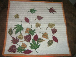 Beautiful decorative cushion with woven autumn leaves