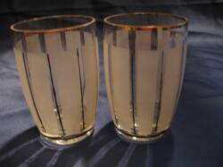 A pair of antique glasses with gold and ground stripes