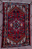 An old hand-knotted oriental wool rug with beautiful colors