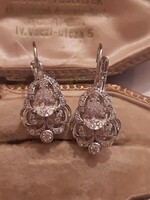 Old-style earrings with drop zirconia stones with a snap closure