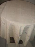Beautiful, machine-embroidered, elegant cream-colored tablecloth with lace inserts