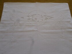 Embroidered, openwork, monogrammed pillow cover.