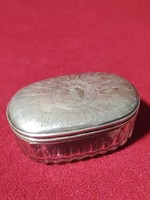 Polished glass container with silver lid pipe holder