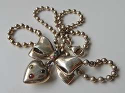 Old gold-plated silver necklace with a bow-shaped pendant and precious stones