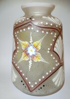 The painted opal bay glass vase, decorated with plastic flowers, has a good body