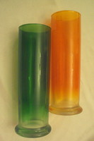 Two colorful (green-orange) glass vases with rimmed bases together.