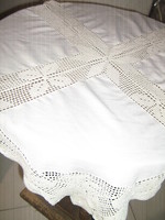 A beautiful tablecloth with a hand-crocheted edge and insert