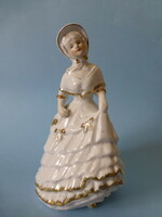 Girl in baroque dress with gilded porcelain hat