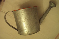 An old children's toy---a small tin watering can with a filter.