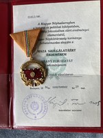 Medal of Merit for Service to the Homeland, gold grade award with a document donating it