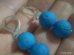 On the other hand, blue painted earrings with real lava stones
