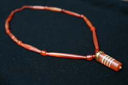 A 2,000-year-old pendant made during the Pyu Empire, a necklace of Burmese carnelian pearls