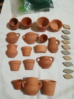 Small earthenware pots, half pots, clay leaves and artificial grass.
