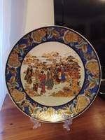 Porcelain decorative plate. Decorated with gold chandelier. Not a wall plate. I will send it with its holder.