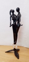 Oblivious to each other, onyx-black Murano glass statue of a couple of dancers
