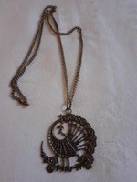 A special, long (perhaps alpaca) necklace with a large peacock pendant