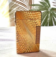 A gold-colored abstract patterned lighter from an Inke Lászl legacy