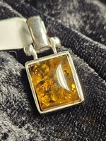 Silver pendant with amber stones