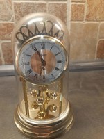 Staiger quartz clock rotating pendulum, gold colored clock. It works
