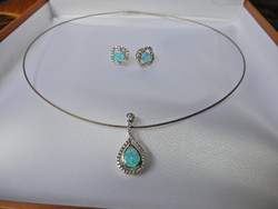 Silver jewelry set decorated with opal and crystal stones