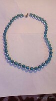 Vintage women's necklace, jewelry strung with minimal iridescent blue eyes