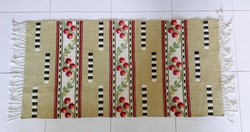 Retro carpet with fringes, small runners on an olive green background with flowers