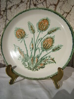 A majolica plate with an ear of wheat and a bouquet of poppies