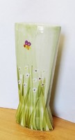 Antique faience vase with wild flowers and bees